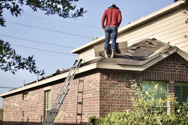 Professional roofer working on a residential roof in La Fayette